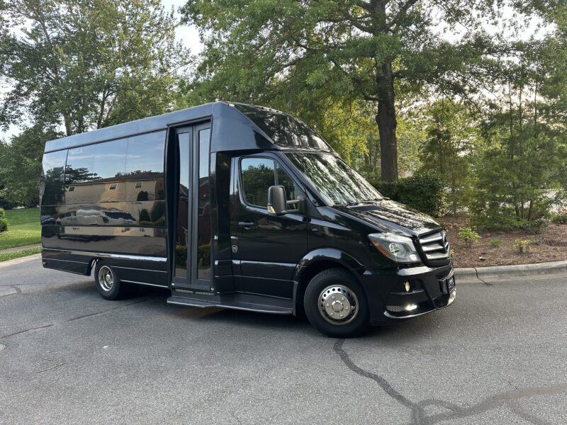 Black 14 passenger Sprinter Van